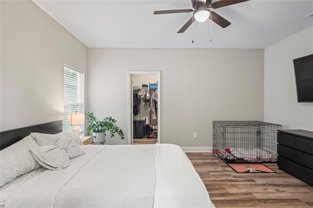 1601 E 98th Ave, Tampa, FL 33612 - bedroom featuring wood finished floors, a spacious closet, baseboards, ceiling fan, and a closet