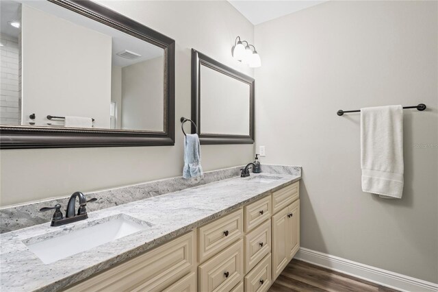 1601 E 98th Ave, Tampa, FL 33612 - full bathroom with baseboards, wood finished floors, and double vanity
