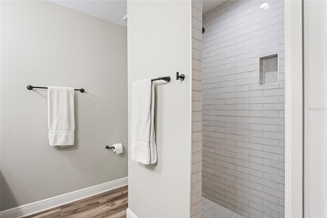 1601 E 98th Ave, Tampa, FL 33612 - bathroom with wood finished floors, a walk in shower, and baseboards