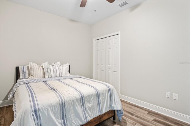 1601 E 98th Ave, Tampa, FL 33612 - bedroom featuring baseboards, wood finished floors, a closet, and a ceiling fan
