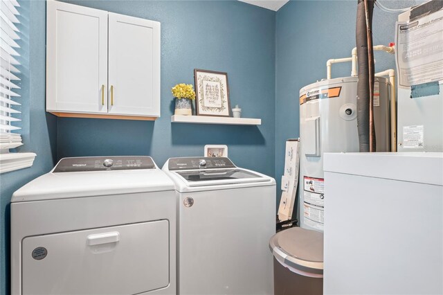1601 E 98th Ave, Tampa, FL 33612 - laundry room featuring cabinet space, washer and dryer, and electric water heater