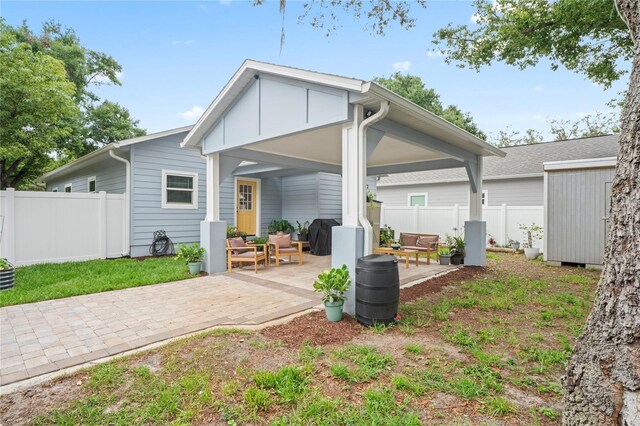 1601 E 98th Ave, Tampa, FL 33612 - back of house with a patio area and an outdoor living space