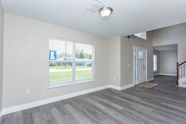 10386 Norvell Rd, Spring Hill, FL 34608 - foyer featuring healthy amount of natural light, wood finished floors, a textured ceiling, and stairs