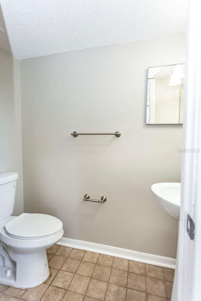 10386 Norvell Rd, Spring Hill, FL 34608 - bathroom with a textured ceiling and tile patterned floors