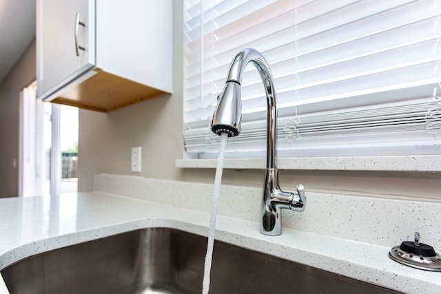 10386 Norvell Rd, Spring Hill, FL 34608 - kitchen view of white cabinets and light stone countertops
