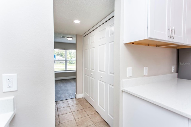 10386 Norvell Rd, Spring Hill, FL 34608 - corridor featuring light tile patterned flooring, recessed lighting, and a textured ceiling