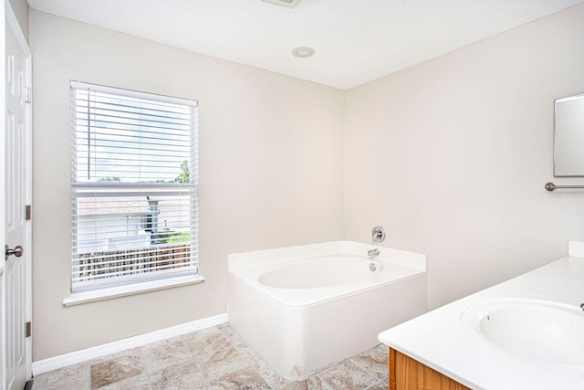 10386 Norvell Rd, Spring Hill, FL 34608 - bathroom featuring vanity, a bath, and a textured ceiling