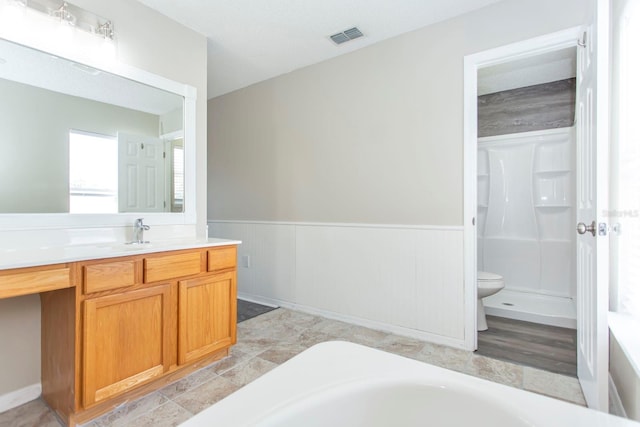 10386 Norvell Rd, Spring Hill, FL 34608 - bathroom with vanity, wainscoting, a tub, and a shower