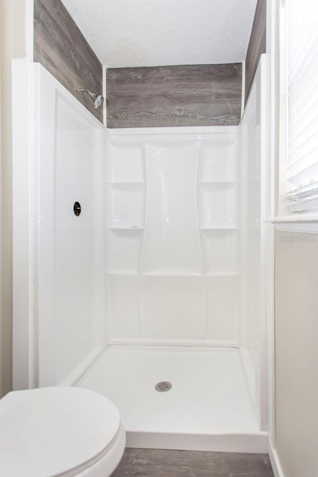 10386 Norvell Rd, Spring Hill, FL 34608 - bathroom featuring a stall shower and a textured ceiling