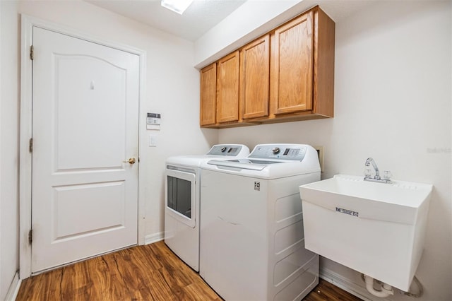 12027 Yellow Finch Ln, Trinity, FL 34655 - washroom featuring washing machine and clothes dryer, cabinet space, dark wood-type flooring, and baseboards