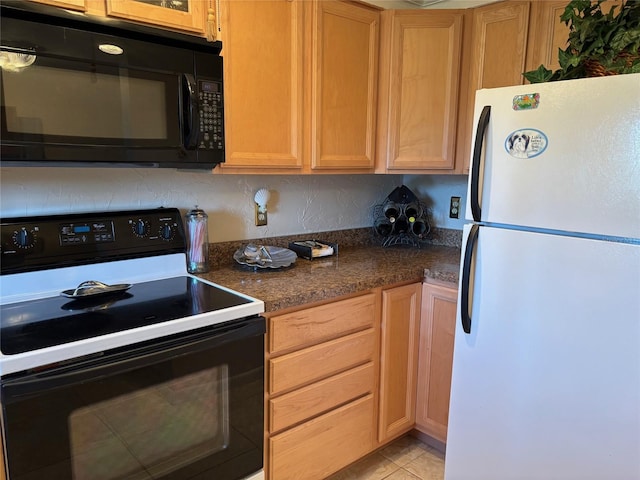 1243 S Martin Luther King Jr Ave Unit C505, Clearwater, FL 33756 - kitchen featuring black appliances and light tile patterned flooring