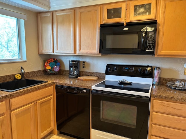 1243 S Martin Luther King Jr Ave Unit C505, Clearwater, FL 33756 - kitchen featuring black appliances, a sink, and glass insert cabinets