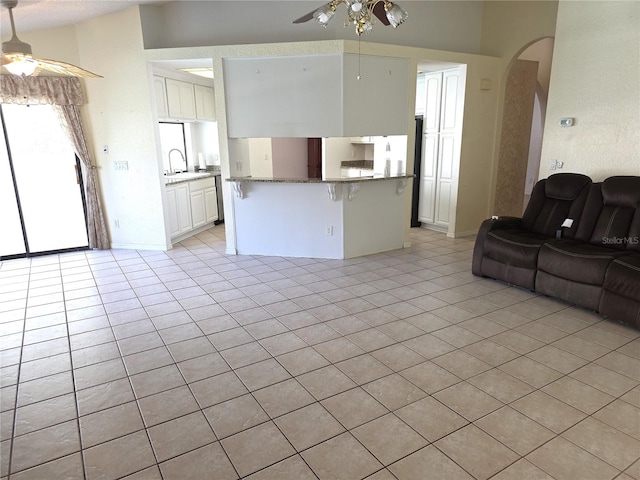 10244 Hoover St, Spring Hill, FL 34608 - living room with ceiling fan, arched walkways, and light tile patterned flooring