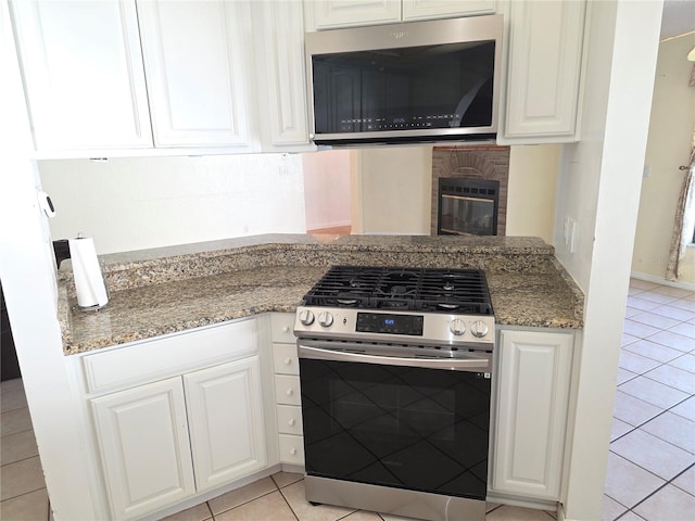 10244 Hoover St, Spring Hill, FL 34608 - kitchen featuring stainless steel appliances, light tile patterned flooring, and white cabinetry