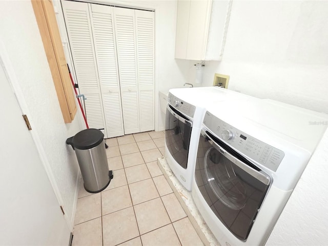 10244 Hoover St, Spring Hill, FL 34608 - laundry area featuring washer and clothes dryer, light tile patterned flooring, and cabinet space