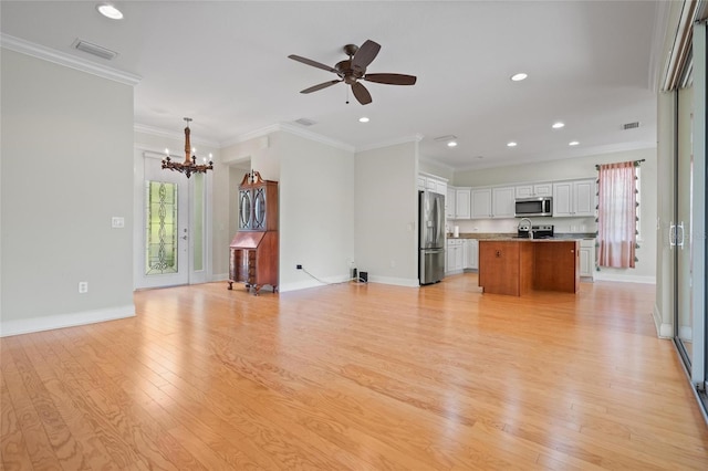 1010 Teal Pointe, Tarpon Springs, FL 34689 - unfurnished living room with a chandelier, light wood-style flooring, crown molding, recessed lighting, and ceiling fan