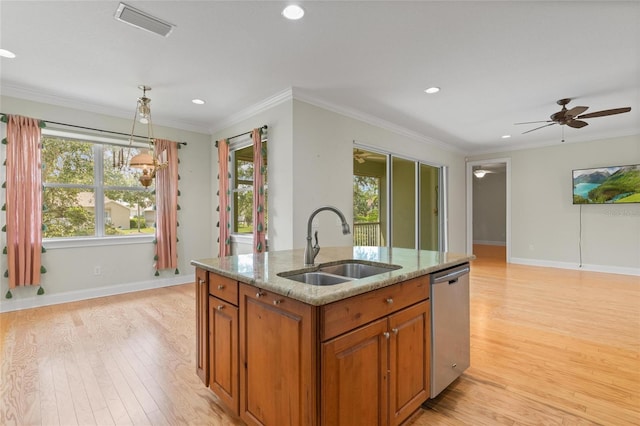 1010 Teal Pointe, Tarpon Springs, FL 34689 - kitchen with dishwasher, brown cabinets, light wood-type flooring, recessed lighting, and light stone counters