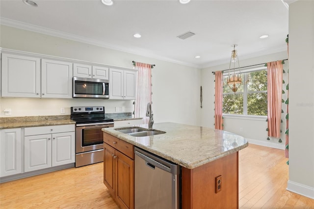 1010 Teal Pointe, Tarpon Springs, FL 34689 - kitchen with appliances with stainless steel finishes, white cabinetry, light stone countertops, crown molding, and recessed lighting