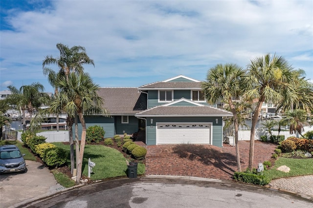 3150 Trident Ter, New Port Richey, FL 34652 - view of front of home with a tile roof, a garage, and driveway