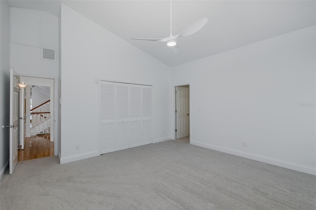 3150 Trident Ter, New Port Richey, FL 34652 - unfurnished bedroom featuring carpet flooring, high vaulted ceiling, a closet, and ceiling fan