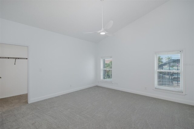 3150 Trident Ter, New Port Richey, FL 34652 - unfurnished bedroom with carpet, high vaulted ceiling, a spacious closet, a ceiling fan, and a closet