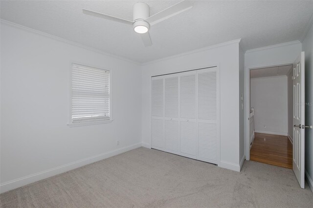 3150 Trident Ter, New Port Richey, FL 34652 - unfurnished bedroom featuring light colored carpet, crown molding, a closet, and ceiling fan