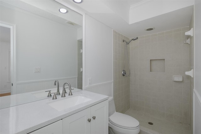 3150 Trident Ter, New Port Richey, FL 34652 - bathroom featuring tiled shower, vanity, and wainscoting
