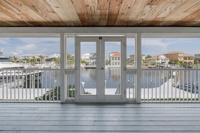 3150 Trident Ter, New Port Richey, FL 34652 - unfurnished sunroom featuring a residential view, a water view, and french doors