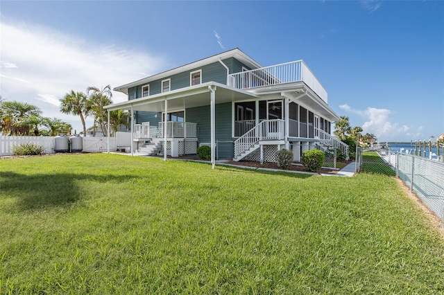 3150 Trident Ter, New Port Richey, FL 34652 - rear view of house with stairs, a fenced backyard, covered porch, and a gate