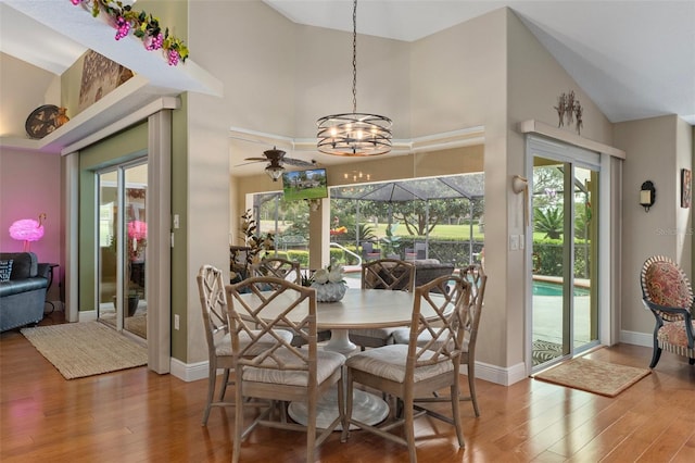 690 E Jenkins Ct, Hernando, FL 34442 - dining room featuring wood finished floors, a chandelier, healthy amount of natural light, high vaulted ceiling, and ceiling fan