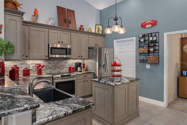 690 E Jenkins Ct, Hernando, FL 34442 - kitchen featuring appliances with stainless steel finishes, high vaulted ceiling, tasteful backsplash, dark stone counters, and decorative light fixtures