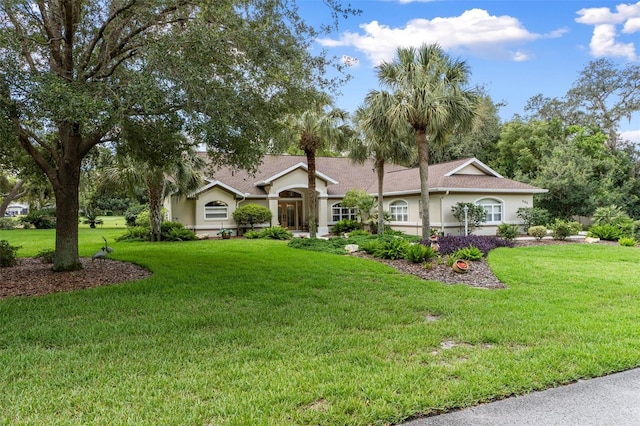 690 E Jenkins Ct, Hernando, FL 34442 - ranch-style home with stucco siding and a front yard