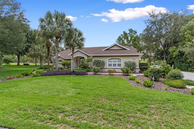 690 E Jenkins Ct, Hernando, FL 34442 - ranch-style house with a front lawn and stucco siding