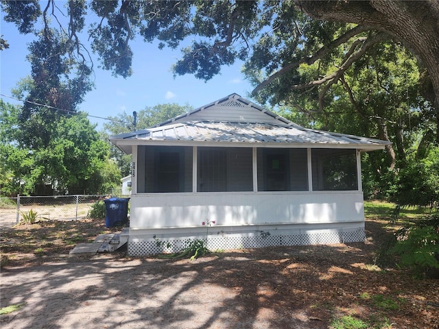 3415 N 51st St, Tampa, FL 33619 - view of side of property with a sunroom and metal roof