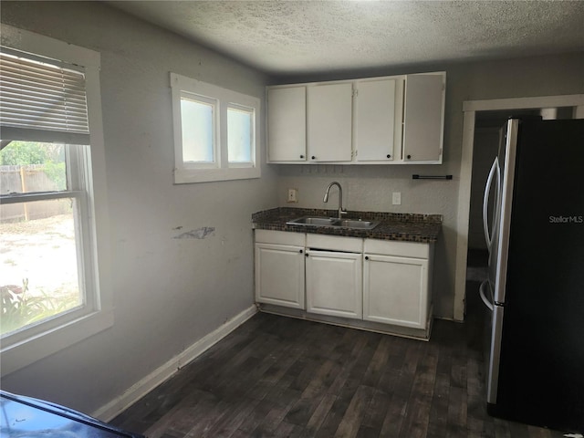 3415 N 51st St, Tampa, FL 33619 - kitchen featuring freestanding refrigerator, a sink, a textured ceiling, dark wood-style flooring, and white cabinets