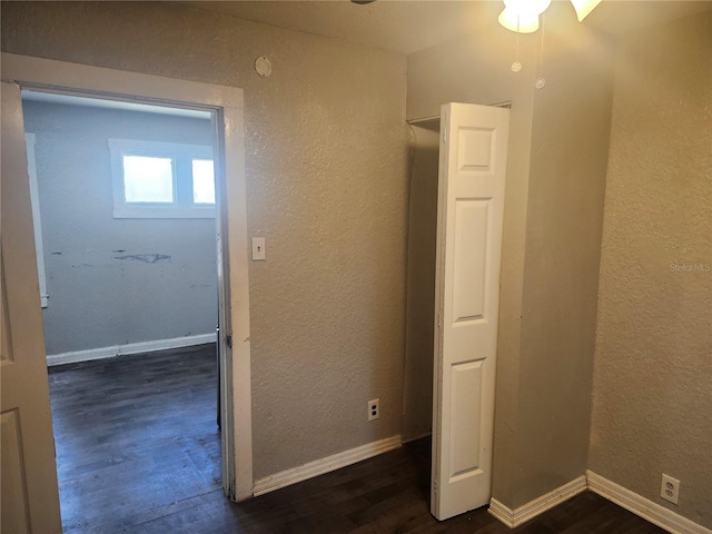 3415 N 51st St, Tampa, FL 33619 - unfurnished bedroom with dark wood-style flooring, a textured wall, and baseboards