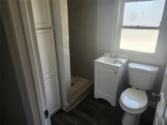 3415 N 51st St, Tampa, FL 33619 - bathroom with toilet, a shower stall, wood finished floors, and vanity