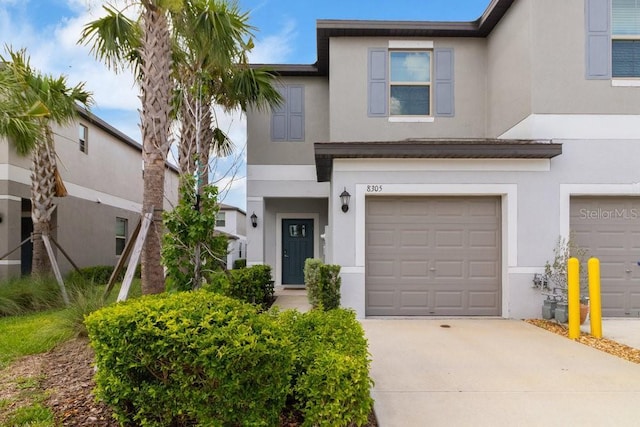 8305 Crescent Oaks Dr, New Port Richey, FL 34655 - townhome / multi-family property with stucco siding, concrete driveway, and an attached garage