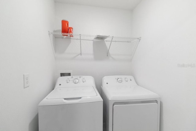 8305 Crescent Oaks Dr, New Port Richey, FL 34655 - laundry area with washer and clothes dryer