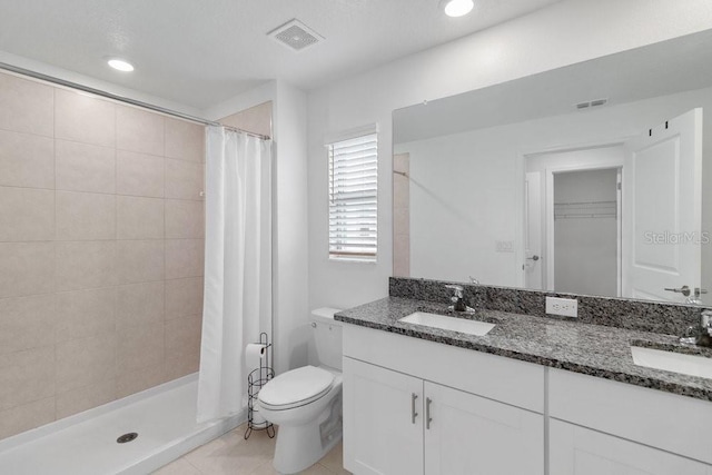 8305 Crescent Oaks Dr, New Port Richey, FL 34655 - full bath with double vanity, a tile shower, tile patterned flooring, recessed lighting, and a walk in closet