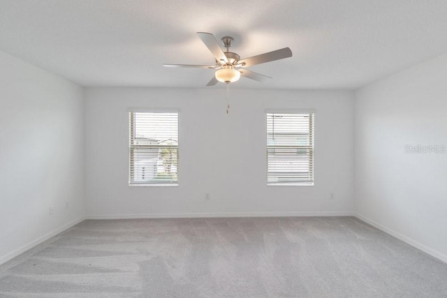 8305 Crescent Oaks Dr, New Port Richey, FL 34655 - empty room featuring light colored carpet and ceiling fan