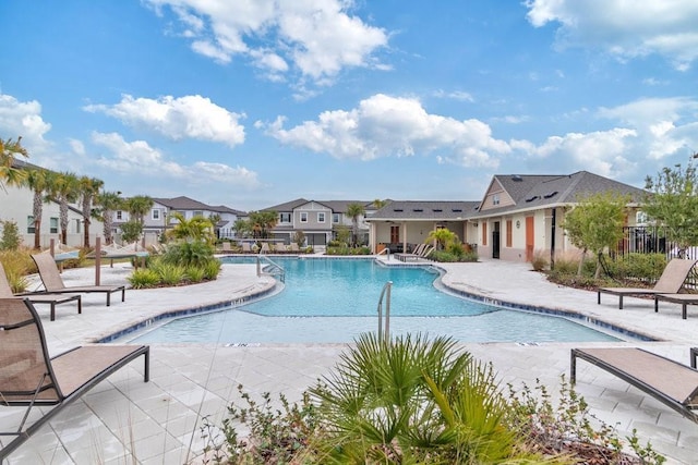 8305 Crescent Oaks Dr, New Port Richey, FL 34655 - community pool featuring a patio and a residential view