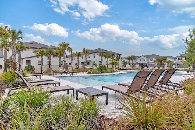 8305 Crescent Oaks Dr, New Port Richey, FL 34655 - community pool featuring a residential view and a patio area