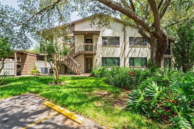 13009 Wedgewood Way Unit 63-D, Hudson, FL 34667 - view of building exterior featuring uncovered parking and stairs