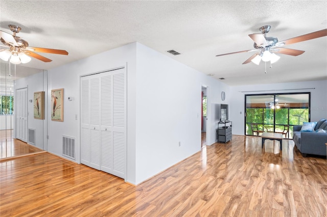 13009 Wedgewood Way Unit 63-D, Hudson, FL 34667 - living room with ceiling fan, wood finished floors, and a textured ceiling