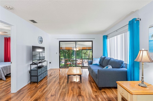 13009 Wedgewood Way Unit 63-D, Hudson, FL 34667 - living area featuring wood finished floors and a textured ceiling