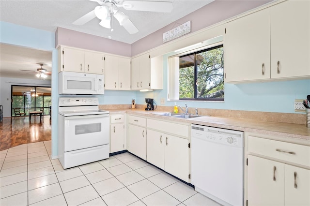 13009 Wedgewood Way Unit 63-D, Hudson, FL 34667 - kitchen with white appliances, a ceiling fan, light countertops, white cabinetry, and light tile patterned flooring