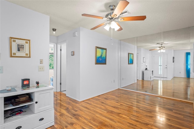 13009 Wedgewood Way Unit 63-D, Hudson, FL 34667 - unfurnished living room with ceiling fan, light wood-type flooring, and a textured ceiling