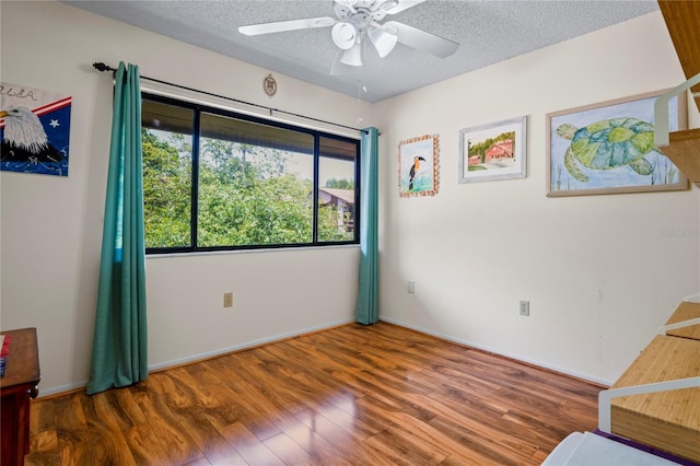 13009 Wedgewood Way Unit 63-D, Hudson, FL 34667 - unfurnished bedroom with a textured ceiling, wood finished floors, and a ceiling fan