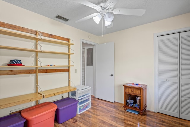 13009 Wedgewood Way Unit 63-D, Hudson, FL 34667 - bedroom featuring wood finished floors, a closet, ceiling fan, and a textured ceiling